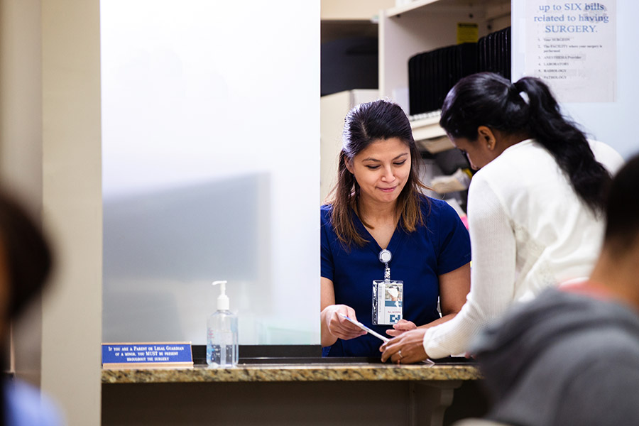 Patient checking in at ER front desk